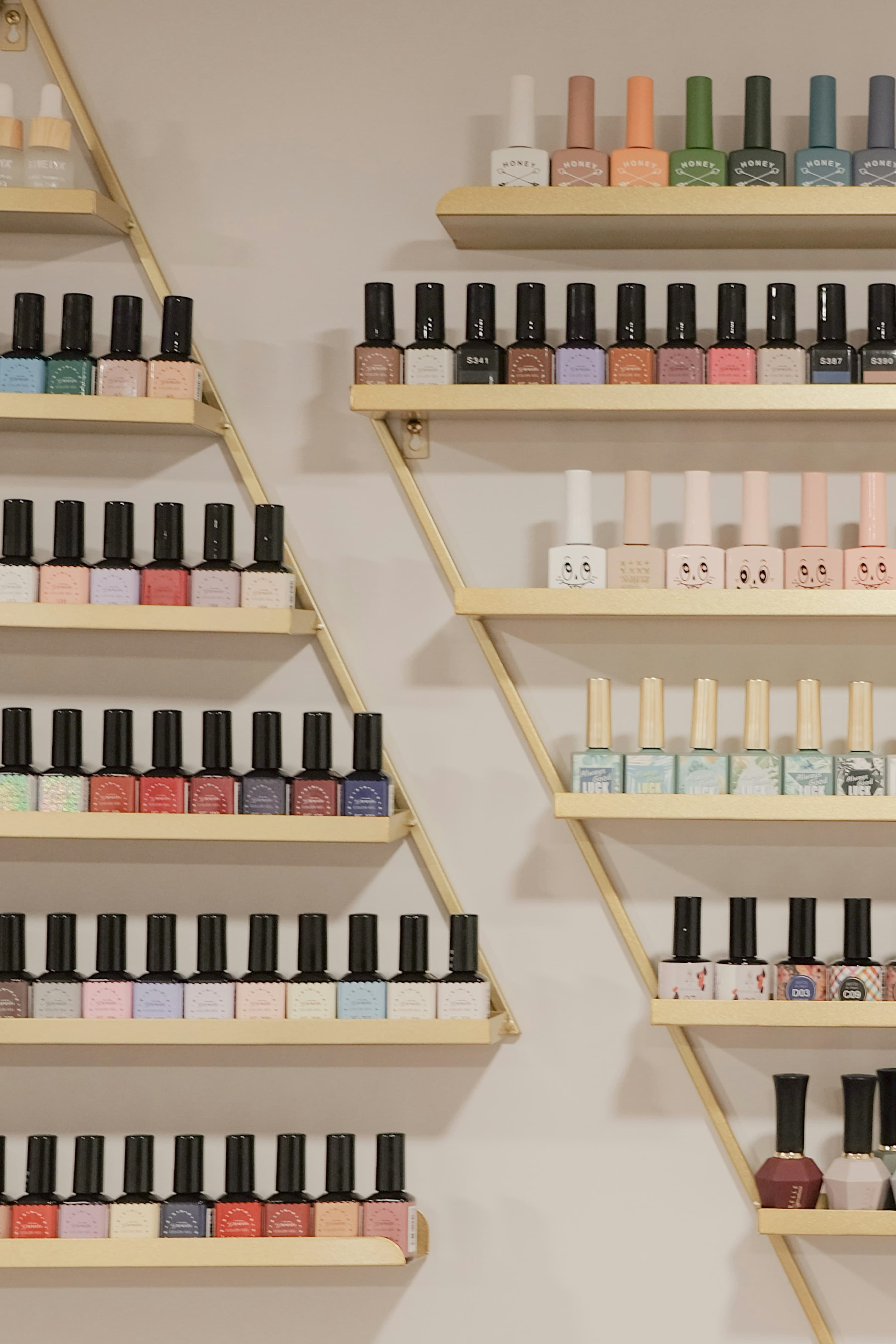 Bottles arranged on a warm wooden shelf in a small studio
